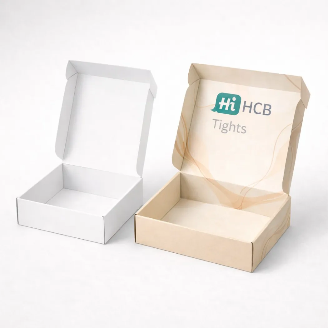 Two open cardboard mailer boxes- displaying a clean white interior and a branded beige design- class=